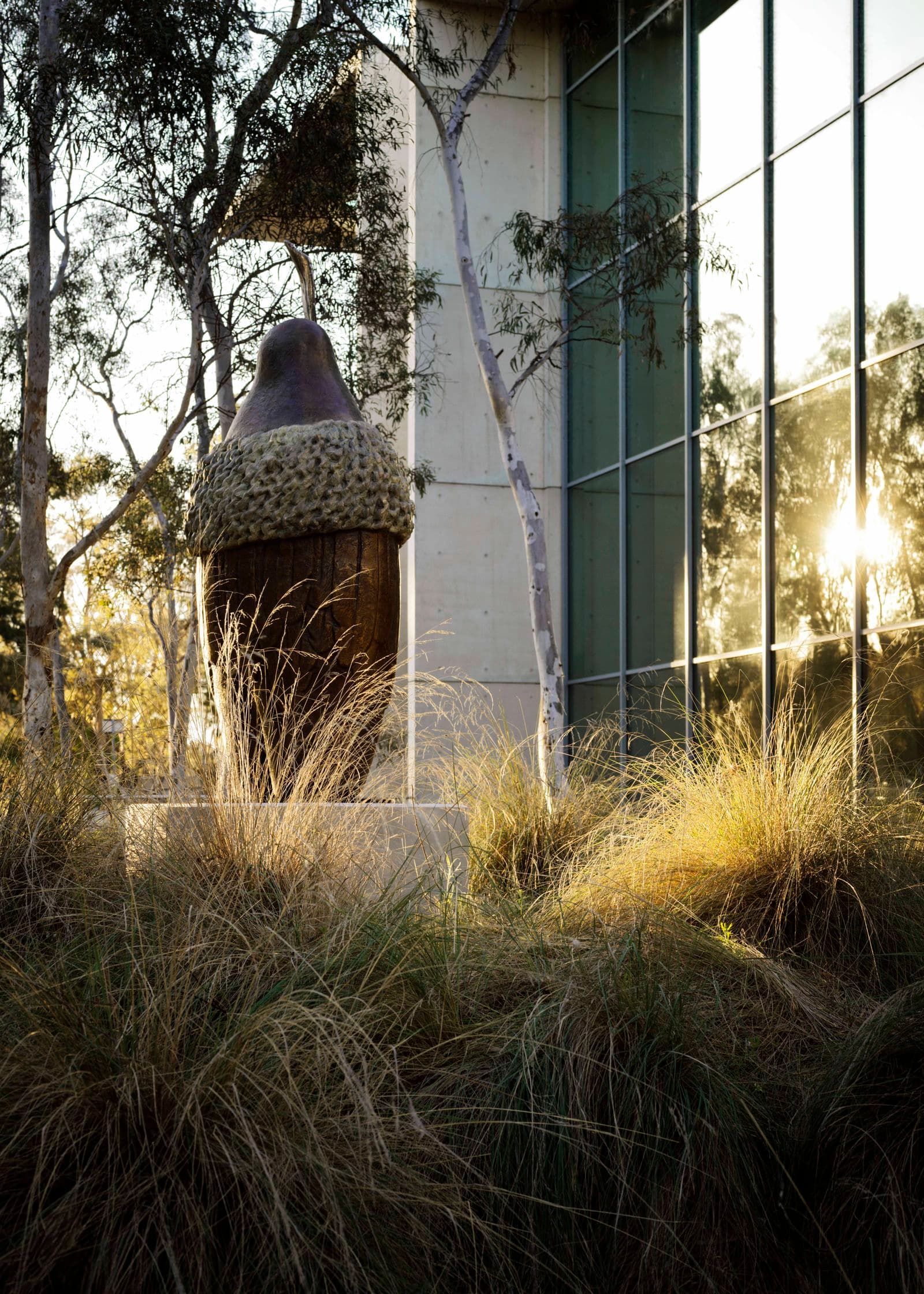 A bronze sculpture in a garden bed