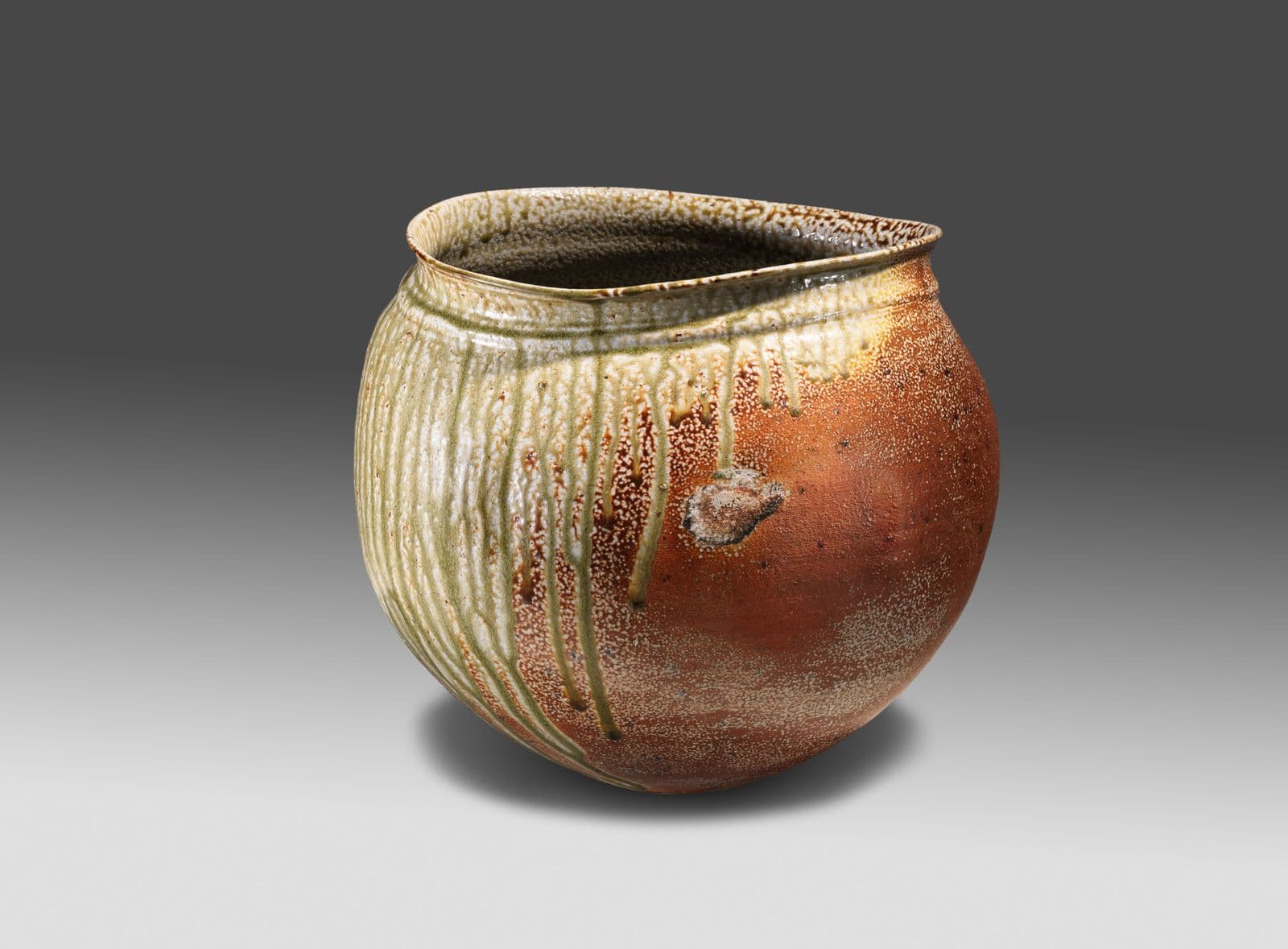 Small, round glazed vase of brown colour