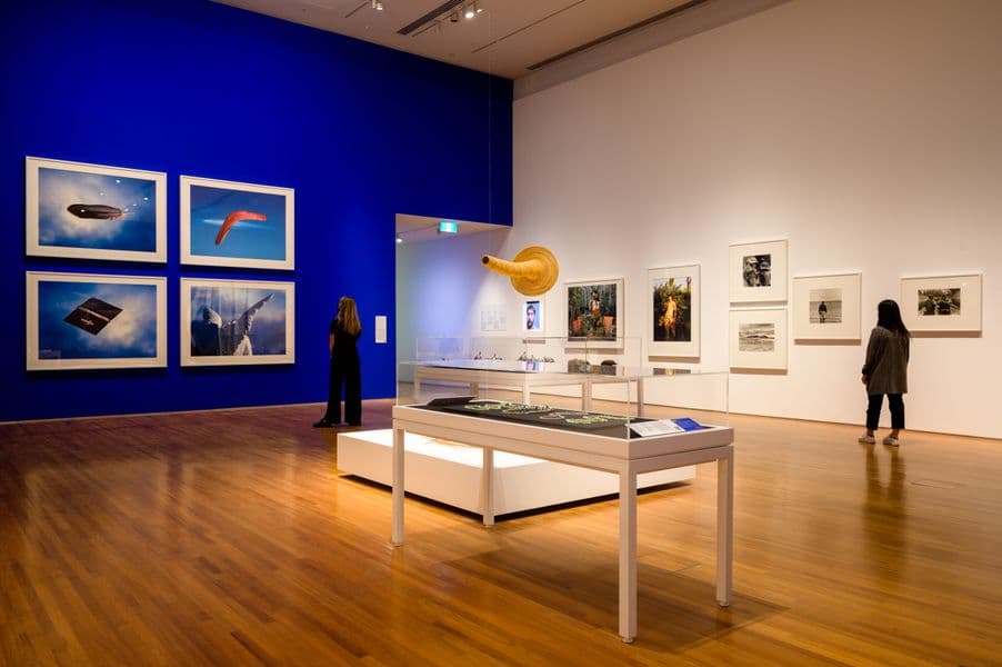 Image of exhibition install with Australian First Nations works and blue wall detail