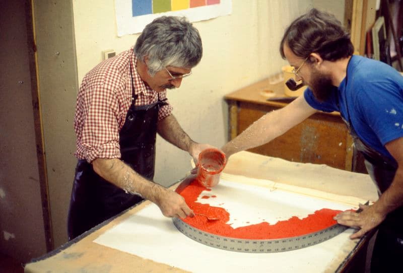 The master printer Kenneth Tyler applies a vivid red paper pulp to a carrier sheet during the production of Ellsworth Kelly's 'Red Curve', 1976
