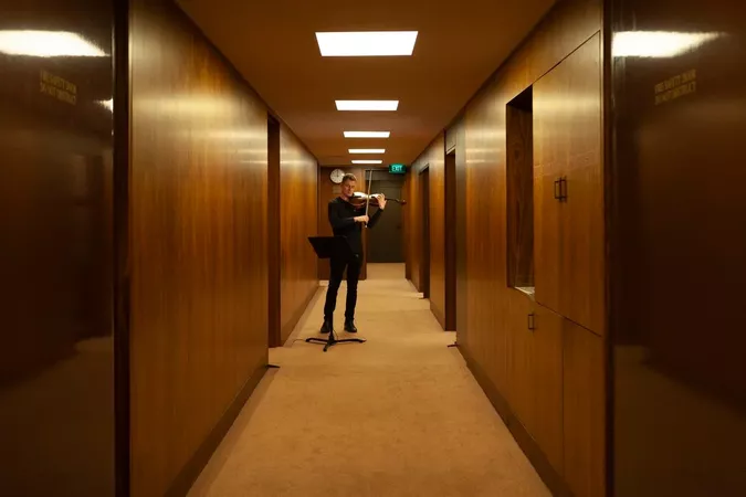 Image of warmly lit hallway with man standing in the centre