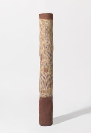 A wide ochre pole with yellow, white and ochre painted motifs