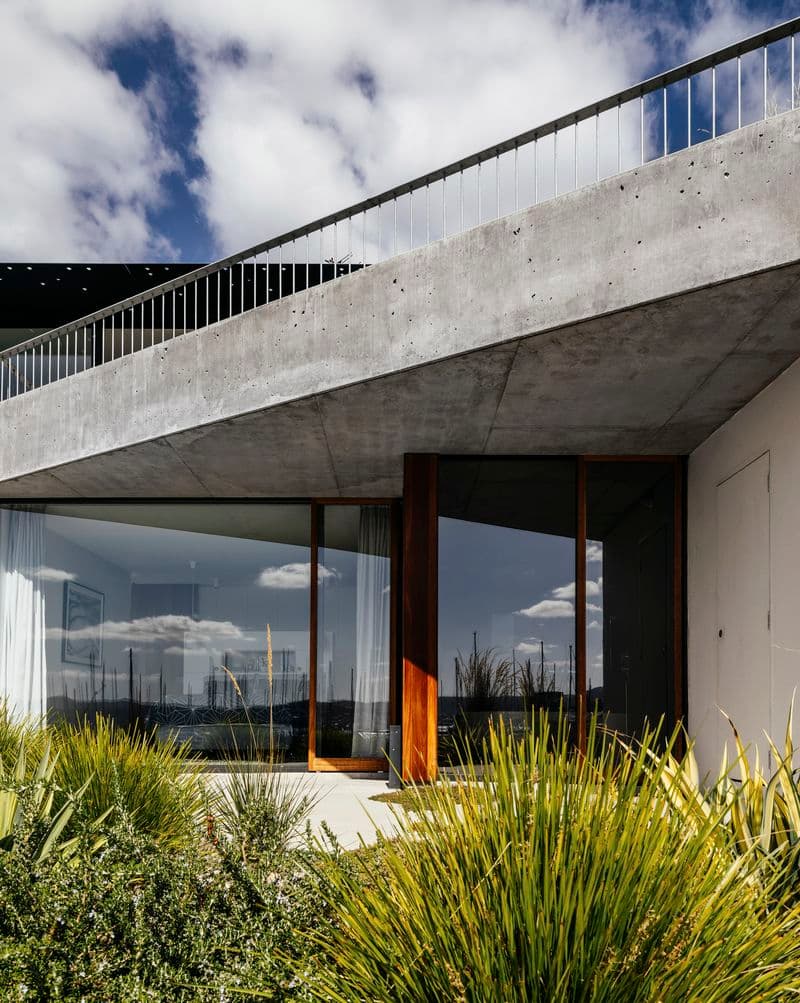 Photograph of domestic exterior with large concrete balcony above