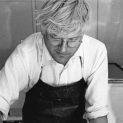 Black and White image of David Hockney working in his studio