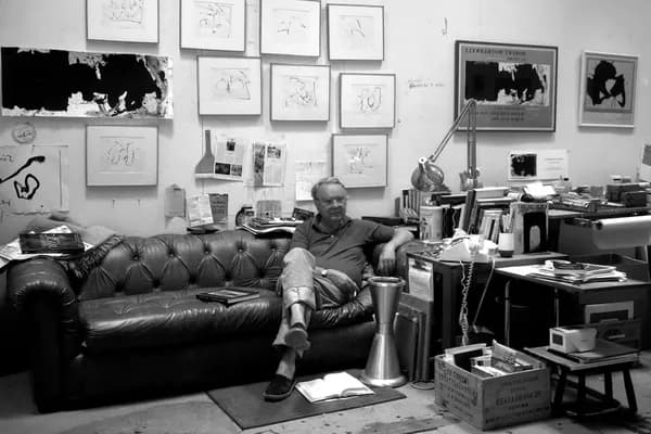 Black and white photograph of Robert Motherwell sitting in his studio,