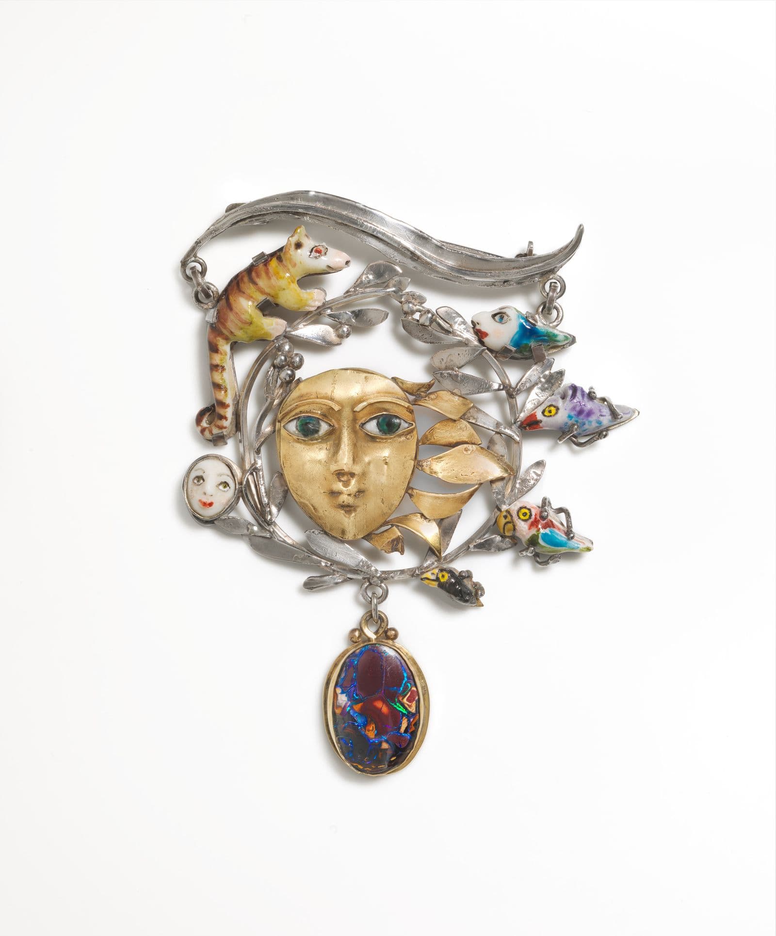 Intricate brooche with animal, leaves, and face forms