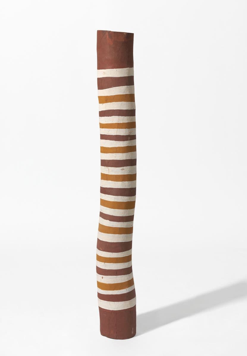 ochre pole with repeating painted white, yellow, and ochre bands