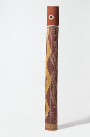 Tall ochre pole with yellow and ochre painted snakes