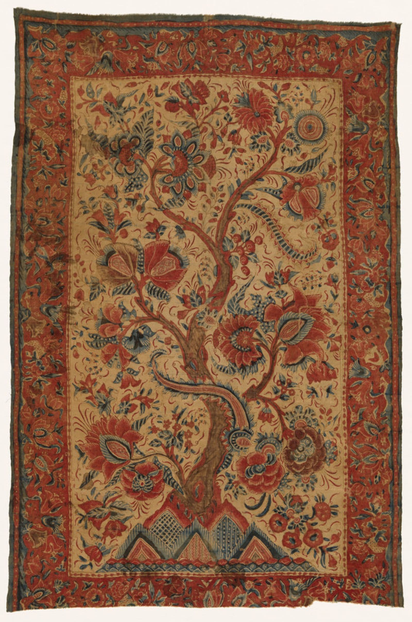 A richly patterned textile with a branch motif and floral borders