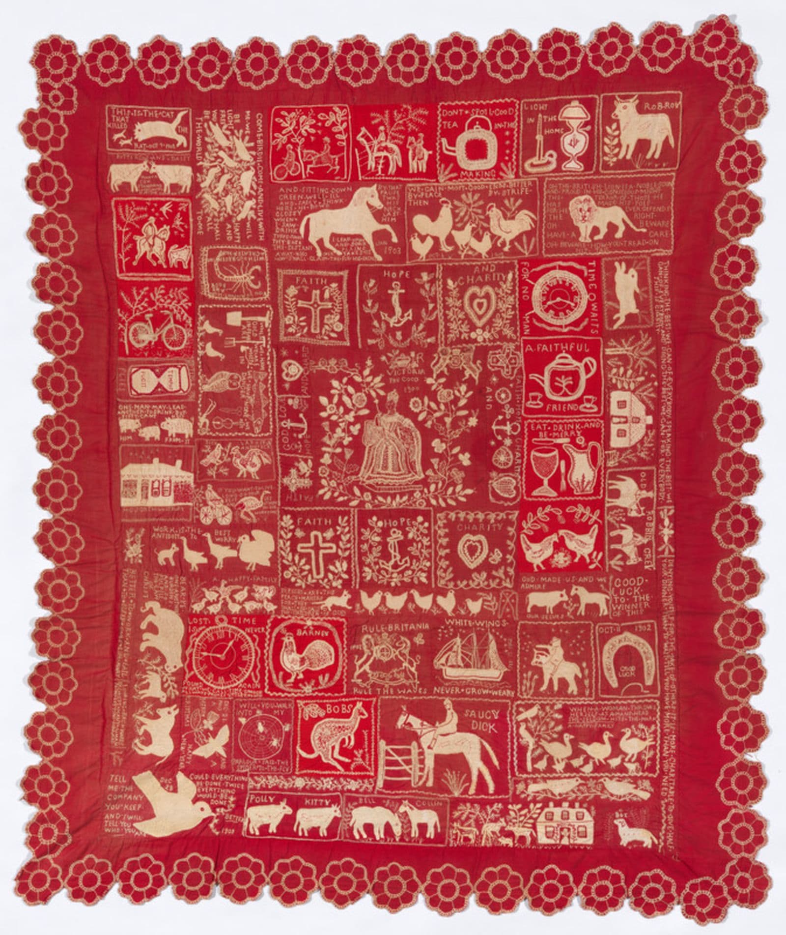 a red hand embroidered quilt with Australian animals and a floral border motif.